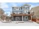 Two-story home with deck, backyard, and snowy landscape at 21093 E Hampden Pl, Aurora, CO 80013