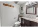 Cozy bathroom features a granite vanity, framed mirror, and neutral wall paint at 17616 Ponderosa Ave, Parker, CO 80134