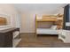 Bedroom featuring a bunk bed, desk, and closet with slat doors at 17616 Ponderosa Ave, Parker, CO 80134