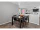 Cozy dining area featuring a wooden table with four chairs and tile flooring at 17616 Ponderosa Ave, Parker, CO 80134