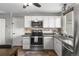 Bright kitchen with stainless steel oven and microwave and white cabinets and backsplash at 17616 Ponderosa Ave, Parker, CO 80134