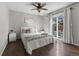 Bright bedroom with sliding glass doors, ceiling fan, and hardwood floors at 17616 Ponderosa Ave, Parker, CO 80134