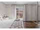 Bedroom with sliding glass doors, hardwood floors, and a mirrored closet at 17616 Ponderosa Ave, Parker, CO 80134