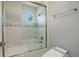 Well-lit bathroom features a tub, shower, and octagon window for natural light at 7400 S Genoa Cir, Centennial, CO 80016