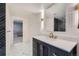 Modern bathroom featuring contrasting black and white tiles and a dark vanity at 7400 S Genoa Cir, Centennial, CO 80016
