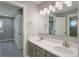 Elegant bathroom featuring double sinks, quartz counters, and modern fixtures at 7400 S Genoa Cir, Centennial, CO 80016