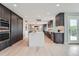 Spacious open kitchen with large island, modern appliances, sleek cabinets, and hardwood floors at 7400 S Genoa Cir, Centennial, CO 80016