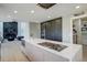 Open kitchen with marble island, modern appliances, hardwood floors, and fireplace visible in background at 7400 S Genoa Cir, Centennial, CO 80016