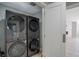Modern stacked washer and dryer in a light-filled laundry room at 7400 S Genoa Cir, Centennial, CO 80016