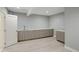 Neutral colored living area with light hardwood flooring and a sink along the back wall at 7400 S Genoa Cir, Centennial, CO 80016