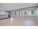 Neutral colored living area with light hardwood flooring, large windows, and a bar at 7400 S Genoa Cir, Centennial, CO 80016