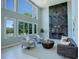 Elegant living room features large windows providing natural light and impressive floor to ceiling fireplace at 7400 S Genoa Cir, Centennial, CO 80016