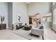 Open concept living room with high ceilings, hardwood floors, and an adjacent modern kitchen at 7400 S Genoa Cir, Centennial, CO 80016