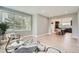 Bright living room with stylish furnishings, hardwood floors, and an open layout to the kitchen at 7400 S Genoa Cir, Centennial, CO 80016