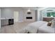 Bright main bedroom with wood-look floors, minibar, marble fireplace and natural light through large windows at 7400 S Genoa Cir, Centennial, CO 80016