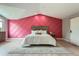 Comfortable main bedroom featuring wood-look floors, a white bed and textured pink accent wall behind the headboard at 7400 S Genoa Cir, Centennial, CO 80016