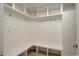 Bright mudroom featuring an L-shaped bench, storage cubbies, hooks and white trim at 7400 S Genoa Cir, Centennial, CO 80016