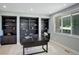 Well-lit home office featuring built-in bookshelves, modern desk, and large window at 7400 S Genoa Cir, Centennial, CO 80016
