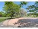 Neighborhood playground with a wooden border and trees providing shade at 7400 S Genoa Cir, Centennial, CO 80016