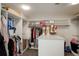 Walk-in closet with custom shelves, hanging racks, a center island, and carpeted floors at 7400 S Genoa Cir, Centennial, CO 80016