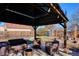 Landscaped backyard featuring a covered patio with seating at 1770 S Yuma St, Denver, CO 80223