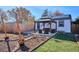 Landscaped backyard featuring a gazebo with seating and an area for planting or outdoor activities at 1770 S Yuma St, Denver, CO 80223