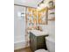 Bathroom featuring stylish vanity and shower/tub with subway tiles and decorative curtain at 1770 S Yuma St, Denver, CO 80223