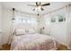 Charming bedroom featuring soft natural light, a ceiling fan, and stylish decor at 1770 S Yuma St, Denver, CO 80223