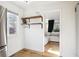 Living room with hardwood floors, floating wood shelves, and bright windows offering natural light at 1770 S Yuma St, Denver, CO 80223