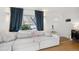 Bright living room featuring a large window, hardwood floors, and a comfortable white sofa at 1770 S Yuma St, Denver, CO 80223