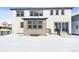 Back exterior featuring a covered porch, stairs and railings, and a snow-covered yard at 3340 Backdrop Ct, Castle Rock, CO 80108