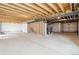 Unfinished basement with exposed beams, concrete floor, and utilities ready for customization at 3340 Backdrop Ct, Castle Rock, CO 80108