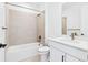 Clean, well-lit bathroom with tile surround bathtub and quartz countertops at 3340 Backdrop Ct, Castle Rock, CO 80108