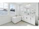 Spa-like bathroom showcasing a freestanding tub, marble countertops, and bright window at 3340 Backdrop Ct, Castle Rock, CO 80108