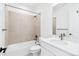 Well-lit bathroom features a shower-over-tub combination, tiled walls and a modern vanity at 3340 Backdrop Ct, Castle Rock, CO 80108