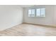 Bright bedroom featuring hardwood floors and natural light from two large windows at 3340 Backdrop Ct, Castle Rock, CO 80108