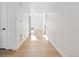 Long hallway featuring hardwood floors leading to a bright, open living space at 3340 Backdrop Ct, Castle Rock, CO 80108