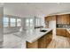 Spacious kitchen featuring a large island, stainless steel appliances, and warm wood cabinetry at 3340 Backdrop Ct, Castle Rock, CO 80108