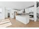 Contemporary kitchen with white cabinetry, island with seating, and stainless steel appliances at 3340 Backdrop Ct, Castle Rock, CO 80108