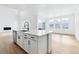 Kitchen island features a sink, dishwasher and seating, all with views of the backyard at 3340 Backdrop Ct, Castle Rock, CO 80108