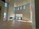 Bright living room featuring a fireplace, high ceilings, large windows, and sliding glass doors to the backyard at 3340 Backdrop Ct, Castle Rock, CO 80108