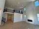 Airy living room with high ceilings, a fireplace, large windows, and a balcony view providing ample natural light at 3340 Backdrop Ct, Castle Rock, CO 80108