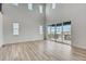 Bright living room with large windows and sliding glass doors to a deck, showcasing the open floor plan at 3340 Backdrop Ct, Castle Rock, CO 80108