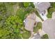 Aerial view of the property showcasing the house, lush greenery, and surrounding neighborhood at 920 Shady Oak Ln, Castle Pines, CO 80108