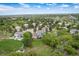 Aerial view of a desirable neighborhood with mature trees, well-maintained homes, and lush surroundings at 920 Shady Oak Ln, Castle Pines, CO 80108