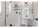 Bathroom featuring frameless shower, bronze fixtures, and pedestal sink at 920 Shady Oak Ln, Castle Pines, CO 80108