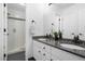 Bathroom with double vanity, granite counters, and walk-in shower at 920 Shady Oak Ln, Castle Pines, CO 80108