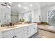 Luxurious bathroom features dual sinks, granite counters, tile backsplash, and a separate tub and shower at 920 Shady Oak Ln, Castle Pines, CO 80108