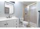 This bathroom features a single sink vanity, toilet, and glass shower at 920 Shady Oak Ln, Castle Pines, CO 80108