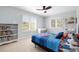 Bright bedroom with ceiling fan, plush carpet, and built-in shelving at 920 Shady Oak Ln, Castle Pines, CO 80108